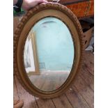 Oval gilt framed bevel edged mirror