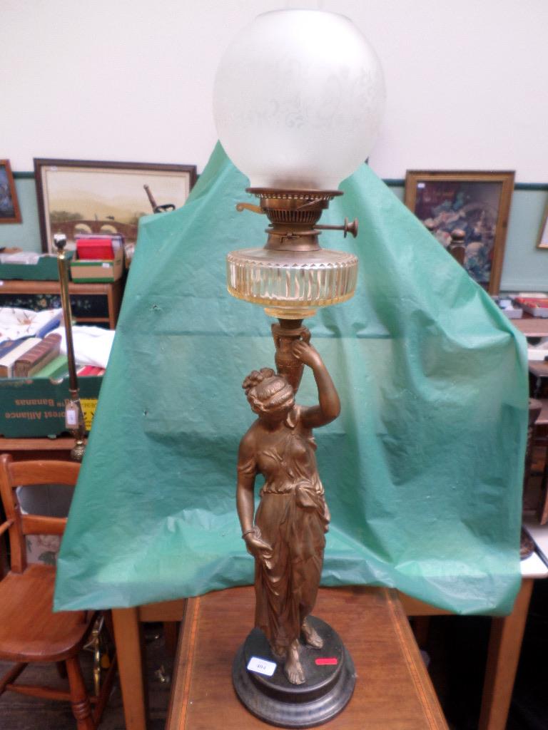 Fine early 20th century oil lamp with etched dome shade supported by a bronze coloured Maiden on