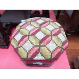 Octagonal sided footstool on bun feet the padded raised top in woolwork finish