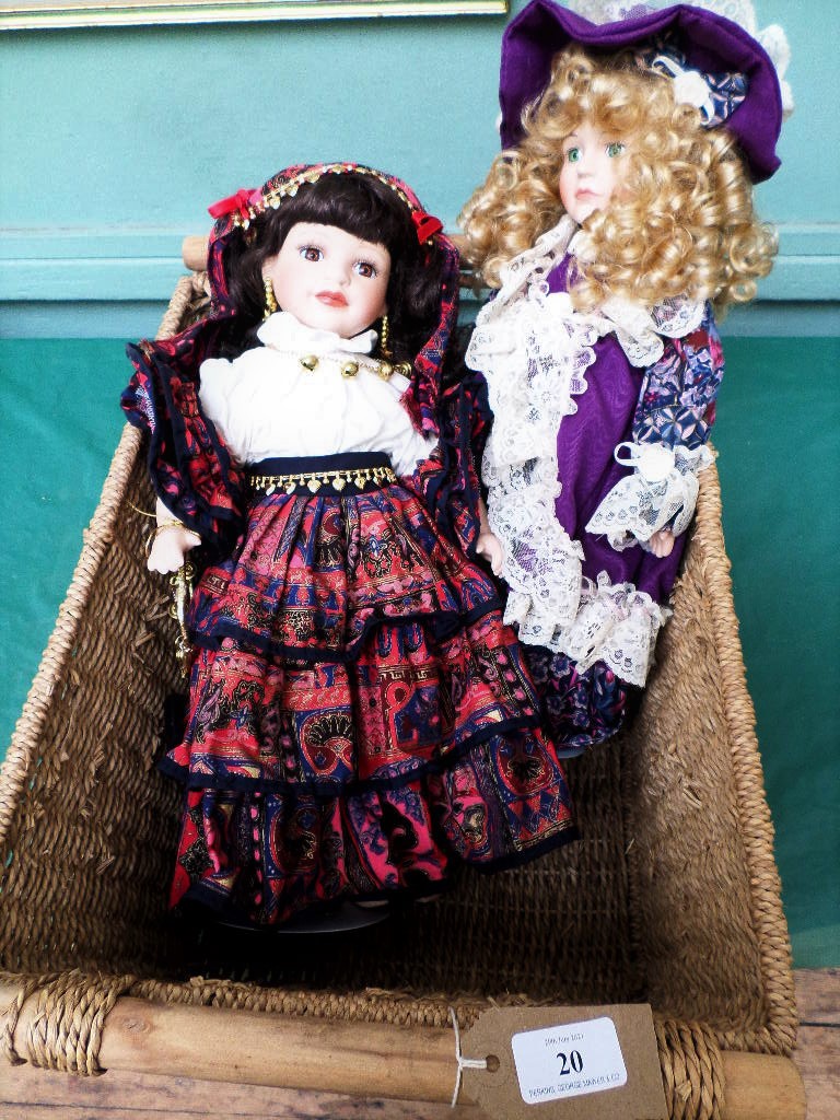 Wicker basket containing 2 dolls each in traditional dress
