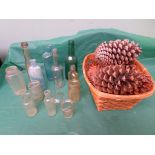 Selection of old bottles, basket of fir cones