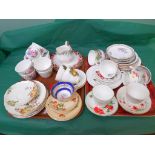 Selection of bone china cups and saucers on two trays