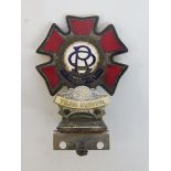 An Order of the Road enamel car badge with '59 Year Driver' attachment, by Spencer of London.
