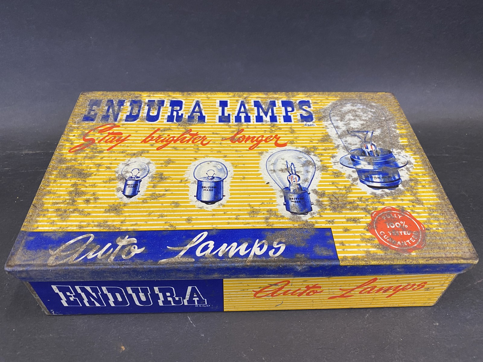 An Endura Lamps rectangular dispensing tin with a complete set of boxed bulbs inside.