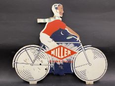 A Miller 'Dynamo Lighting' die-cut pictorial tin advertising sign in the form of a man riding a
