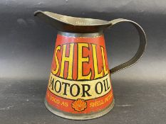 A rare and early Shell Motor Oil quart measure in excellent condition, bearing the words 'As Good As