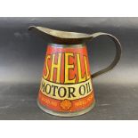 A rare and early Shell Motor Oil quart measure in excellent condition, bearing the words 'As Good As