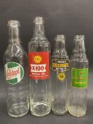 A Shell X-100 Motor Oil quart bottle, a Wakefield Castrol quart and two pint oil bottle.