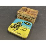 Two motorcycle puncture repair kit tins.