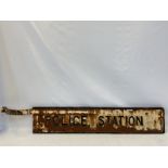 A 'Police Station' cast iron double sided directional road sign with partial bracket, 49 1/2 x 8"