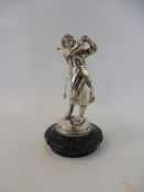 A good quality car accessory mascot in the form of a lady golfer, mounted on a radiator cap.