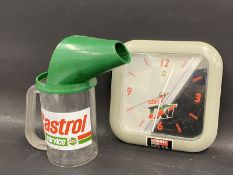 A Castrol one litre plastic measure and a Castrol TXT battery operated wall clock.