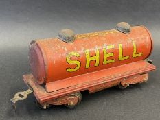 A Hornby O gauge tinplate model railway tanker bearing Shell and BP advertising.