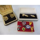 A cased pair of K.L.G. spark plug cufflinks, a pair of John Bull cufflinks and various pin badges