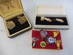 A cased pair of K.L.G. spark plug cufflinks, a pair of John Bull cufflinks and various pin badges