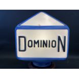 A Dominion three sided glass petrol pump globe with raised lettering, two damaged corners, old