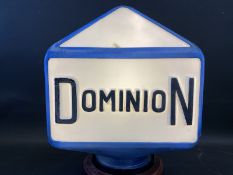 A Dominion three sided glass petrol pump globe with raised lettering, two damaged corners, old