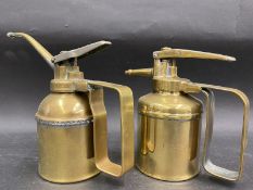 A good quality polished brass Enots oiler and one other.