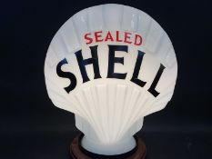 A reproduction Sealed Shell glass petrol pump globe, good condition.