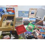 A box of car brochures plus various books and three Esso service guide sheets.