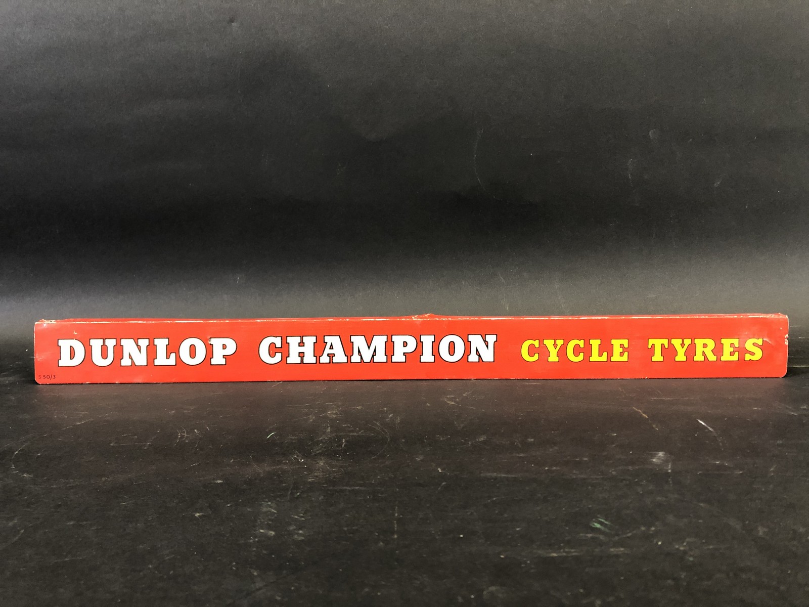 A Dunlop Champion Cycle Tyres shelf strip.