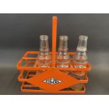 An eight division oil bottle rack, possibly non original, bearing Vigzol decals plus three Vigzol