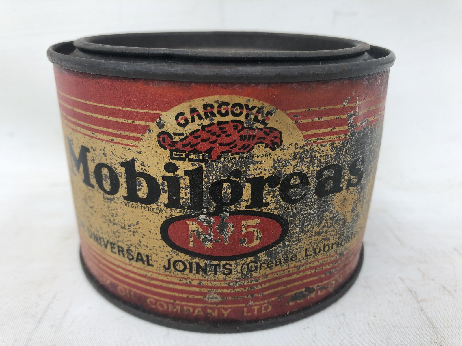 A Gargoyle Mobil Grease no. 5 circular tin.