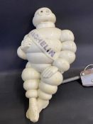 A Michelin Mr Bibendum figure, from an air pump, mounted on a bracket.