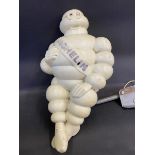 A Michelin Mr Bibendum figure, from an air pump, mounted on a bracket.