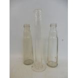 A Shell measuring tube and two glass oil bottles.
