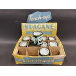 A quantity of Nuagane touch-up motorcycle paint tins in a counter top display box.