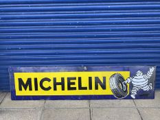 A Michelin rectangular enamel sign with image of Mr. Bibendum rolling a tyre at one end, 77x 18".
