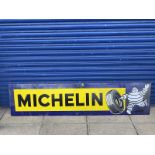 A Michelin rectangular enamel sign with image of Mr. Bibendum rolling a tyre at one end, 77x 18".