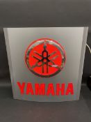 A Yamaha illuminated garage forecourt lightbox.