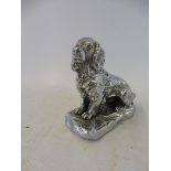 A Desmo car accessory mascot in the form of a seated spaniel.