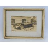 A small framed and glazed 1946 photograph of a racing car, bearing signature in pen and date.
