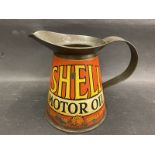 A Shell Motor Oil quart measure bearing the words 'As Good As Shell Petrol'.