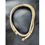 A canvas petrol pump hose, approx 3/4" diameter, with brass fittings.