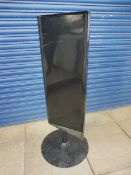 A garage forecourt black painted spinning advertising sign.