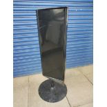 A garage forecourt black painted spinning advertising sign.