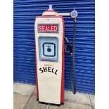 An Avery Hardoll electric petrol pump, in Shell livery with rubber hose and nozzle.