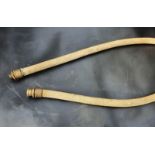 A canvas petrol pump hose, larger bore approx 1" diameter, with brass fittings.