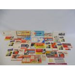 A collection of garage ink blotters, all covered in advertising, various brands including India