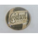 A Wakefield Castrol Motor Oil glass paperweight.