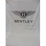 A large Bentley flag bearing hand-written text for 'Le Mans 2002 Mike & Graham 4th', 44 x 77 1/2".