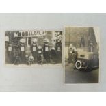 An early black and white postcard depicting a garage scene of four petrol pumps, all with globes,