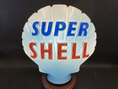A blue Super Shell glass petrol pump globe by Hailware, in very good condition, minor chips to neck,