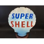 A blue Super Shell glass petrol pump globe by Hailware, in very good condition, minor chips to neck,