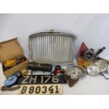 A box of assorted car parts, including a radiator grille, spot lamps etc.