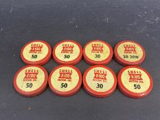 Eight Shell X-100 oil bottle caps.